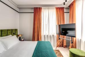 a bedroom with a bed and a flat screen tv at Hotel Santa Maria Maggiore in Rome