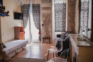 a small room with a bed and chairs in it at Hotel de La Paix in La Rochelle