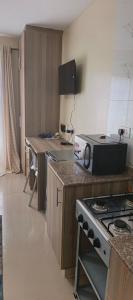 a kitchen with a stove and a counter top at STADEVIEW MODERN STUDIOs in Gatunga +5 photos