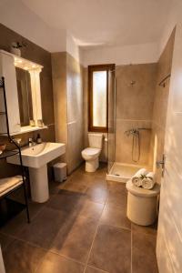 a bathroom with a sink and a toilet and a shower at Epidavros View Villas in Ancient Epidauros +30 photos
