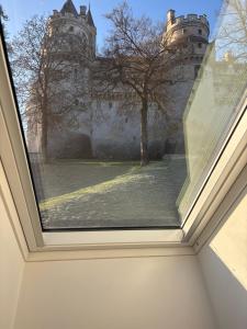 a view from a window of a castle at Résidence ARTHUS Thamarys in Pierrefonds