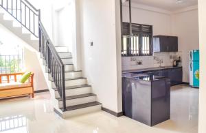 a kitchen with a staircase in a house at Sea Line Villa in Galle