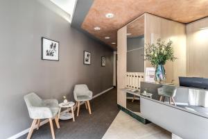 a waiting room with chairs and a mirror at Hotel Santa Maria Maggiore in Rome