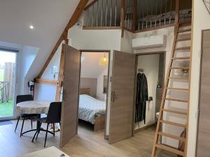 a room with a loft bed and a bedroom at Séjour à la campagne - Logement cosy et chaleureux in Courgains +11 photos
