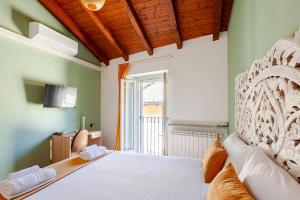 a bedroom with a large bed with a wooden headboard at Like Home XX Settembre in Sesto Calende