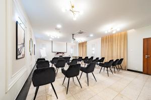 a conference room with black chairs and a projection screen at Hotel Fero Express POKOJE KLIMATYZOWANE AC in Krakow