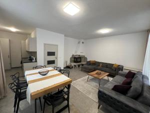 a living room with a couch and a table at Четири сезона 12 in Stoykite