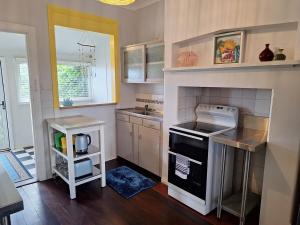 a kitchen with a sink and a stove top oven at South Bunbury Beach Shack in Bunbury