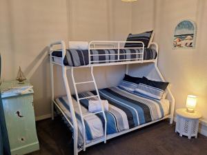 a couple of bunk beds in a room at South Bunbury Beach Shack in Bunbury
