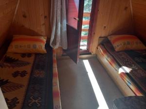 a room with two beds in a cabin at jezerski dragulj in Lazići