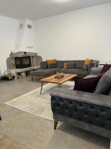 a living room with a couch and a coffee table at Четири сезона 12 in Stoykite