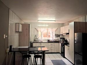 a kitchen with a table and some chairs in it at Just Property Zululand in Richards Bay