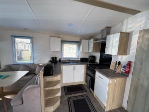 a kitchen and living room of a caravan at Captain's Cabin - Brixham - with designated parking in Brixham