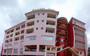 a large building with a red and white at Summer Oasis in Kitui