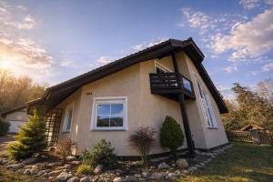 a small house with a window on the side of it at Fleiš Residence villa - jacuzzi included in Most
