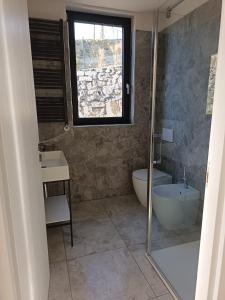 a bathroom with a tub and a sink and a toilet at Retrait Lake Como Private Design Retreat with Lake View in Perledo +41 photos