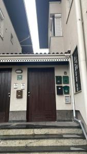 a pair of doors on a building with stairs at Mills Apartment, Baščaršija-Stari Grad in Sarajevo