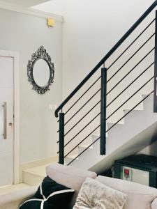 a living room with a couch and stairs at Stylish and spacious room in a quiet environment in Dawhwenya