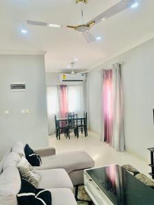 a living room with a couch and a table at Stylish and spacious room in a quiet environment in Dawhwenya