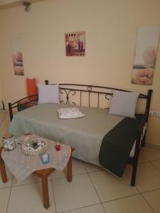 a bedroom with a bed and a table at Aellia-Beautiful apartment in Vathi Samos in Vathý