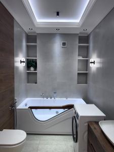 a bathroom with a tub and a toilet and a sink at Boulevard in Samarkand
