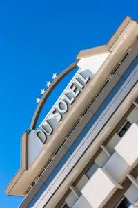 a sign on the side of a hotel at Hotel Du Soleil in Rimini