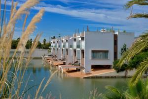 a building sitting on top of a body of water at Eden Island Villa - Bouznika in Bouznika