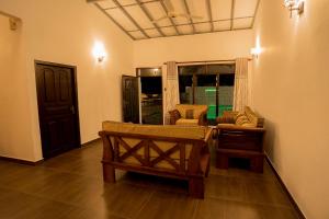 a living room with a bench and chairs in a room at Villa Sanchana in Galle +37 photos