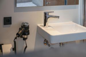 a hair dryer is next to a sink in a bathroom at Roatel Willich A44 my-roatel-com in Willich
