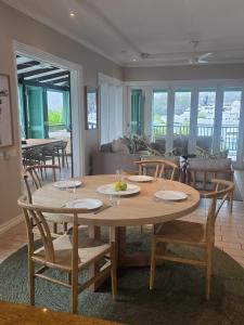 a wooden table and chairs in a living room at Eden Island Gem in Eden Island