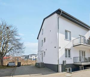 a white building with balconies on the side of it at Prime Host Balcony Apartment in Karlsruhe