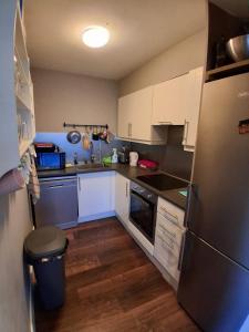a kitchen with white cabinets and a stainless steel refrigerator at Bedroom in Blanchardstown in Blanchardstown