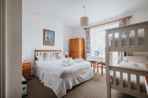 a bedroom with two beds and a bunk bed at Y Pengwern in Ffestiniog
