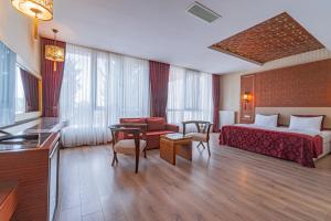 a hotel room with a bed and a couch at Kronos Hotel in Golbası +25 photos