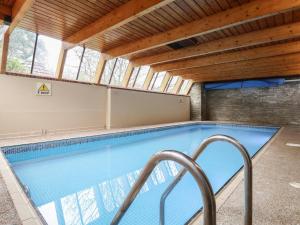 a swimming pool with a wooden ceiling at Watermouth Castle, Harbour Apartment in Ilfracombe +30 photos