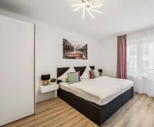 a bedroom with a large bed and a ceiling fan at Prime Host Balcony Apartment in Karlsruhe