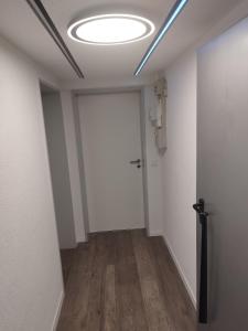 an empty hallway with a door and a light at Dreiländereck erkunden in Lörrach +17 photos