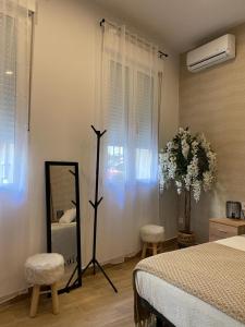 a bedroom with a bed and a mirror and a dresser at Thor Hostal Boutique in Alicante