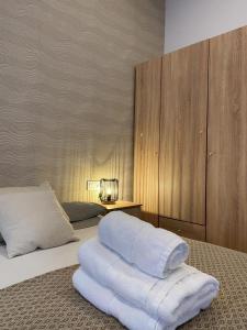 a bedroom with a bed with white towels on it at Thor Hostal Boutique in Alicante +45 photos
