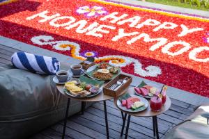 a table with plates of food on top of a couch at Subu Utamas Villas in Ubud