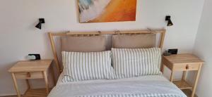 a bedroom with a bed with two night stands at CASA LUKASA 39c in Costa Calma