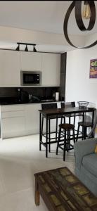 a living room with a table and a kitchen at CASA LUKASA 39c in Costa Calma