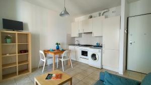 a small kitchen with a table and a stove top oven at Monolocale DIRETTAMENTE SUL MARE cod 509 in Porto Recanati