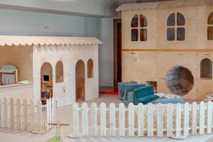 a toy house with a white picket fence at FOREST Family Resort Ustka in Ustka