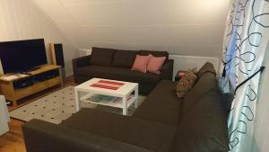 uma sala de estar com um sofá e uma televisão em Kirkenes Lodge em Kirkenes