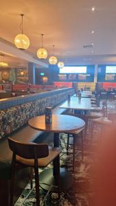 a restaurant with tables and chairs and a bar at Heavenly Huts GC056 in Saint Osyth