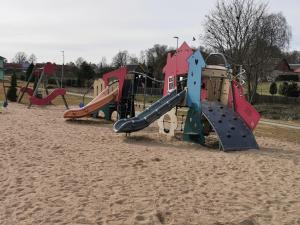 a group of playground equipment in the sand at Jõe House in Valga