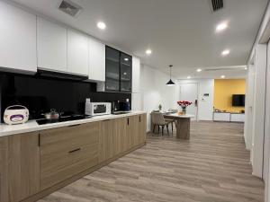 a kitchen with white cabinets and a counter top at GEM Hotel And Residence in Hanoi