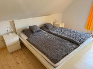 a bedroom with a large bed with two night stands at Ferienhaus Halbritter Pouch 2 in Pouch