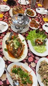 a table full of plates of food on a table at บ้านไร่คุณนาย in Ban Sap Bon